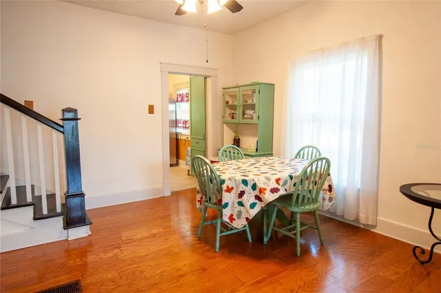 a dining room with furniture and wooden floor