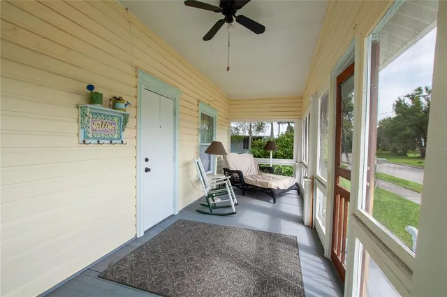 a view of a living room and porch with furniture