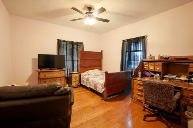 a bedroom with a bed and flat screen tv