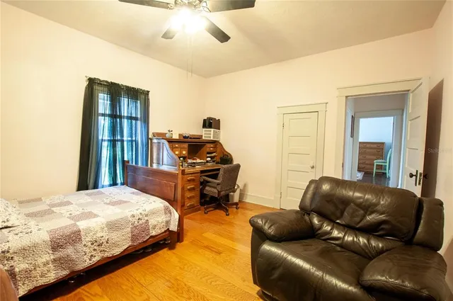 a bedroom with a bed couch and a window