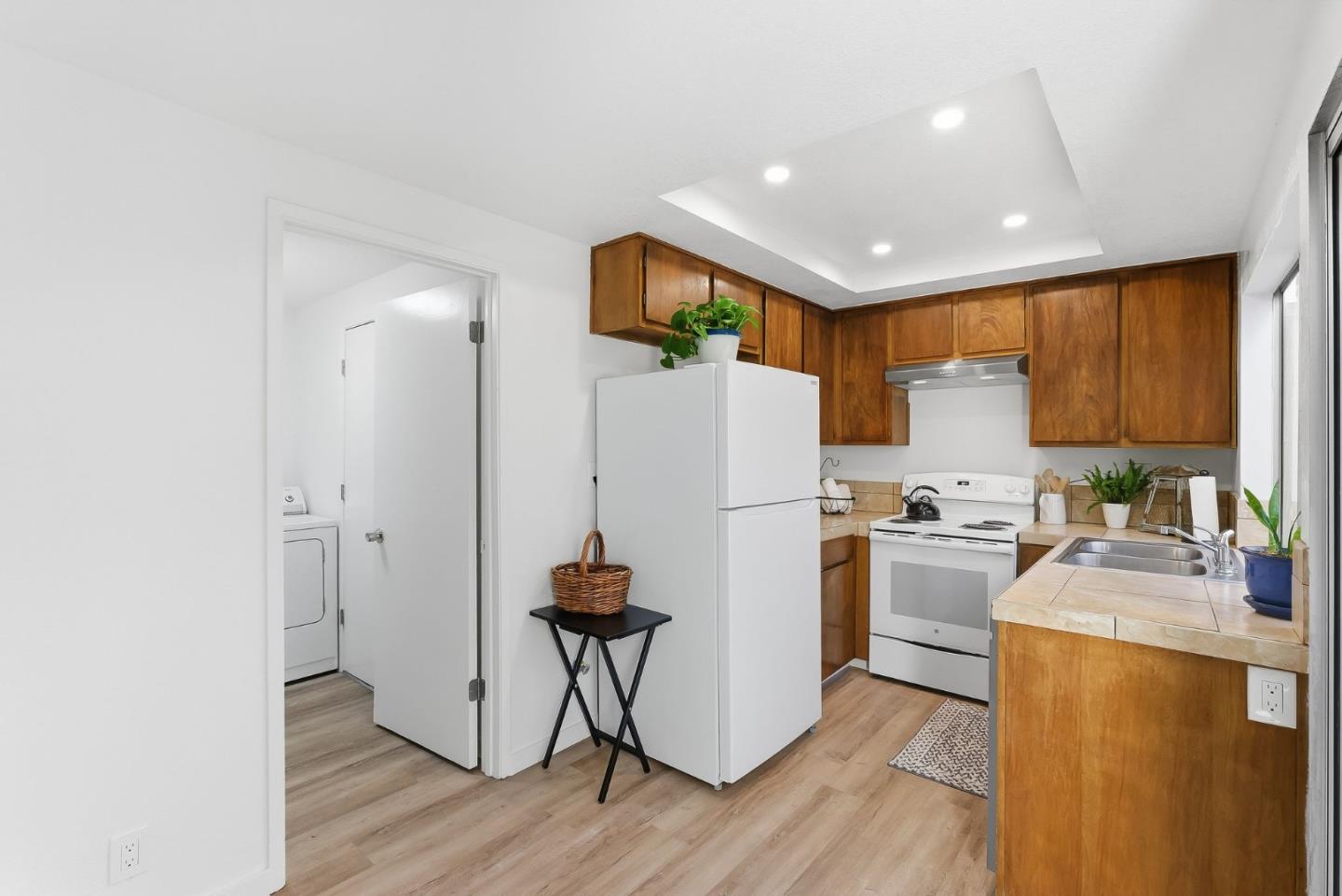 7147 Rouse Court San Jose, CA 95139 - Photo 12 of 36 a kitchen with sink a refrigerator and a stove top oven