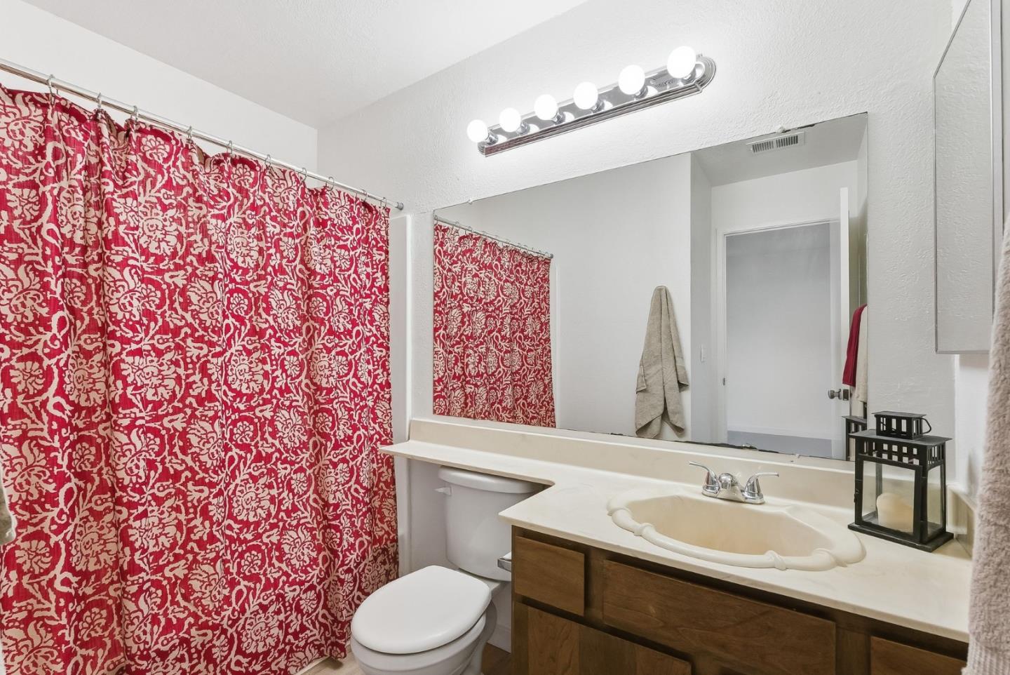 7147 Rouse Court San Jose, CA 95139 - Photo 30 of 36 a bathroom with a sink and a mirror