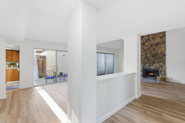 a view of a livingroom with wooden floor and furniture