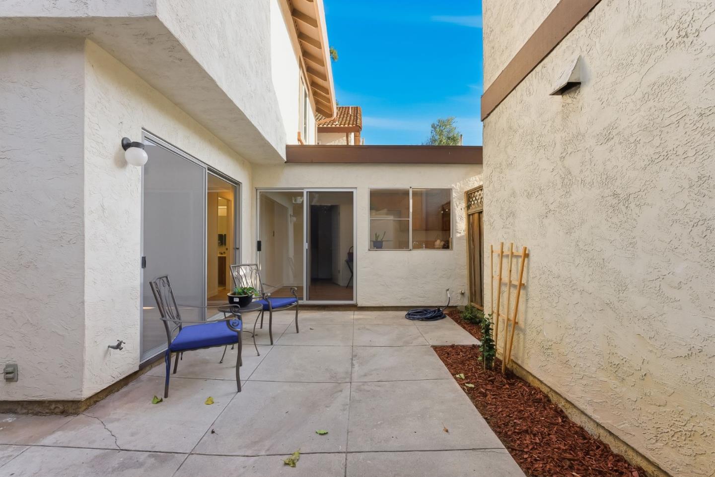 7147 Rouse Court San Jose, CA 95139 - Photo 33 of 36 a view of a porch with a table and chairs and couches with wooden floor