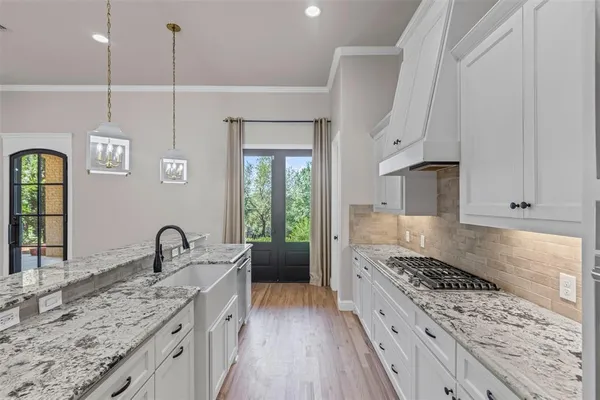 a kitchen with sink stove and refrigerator
