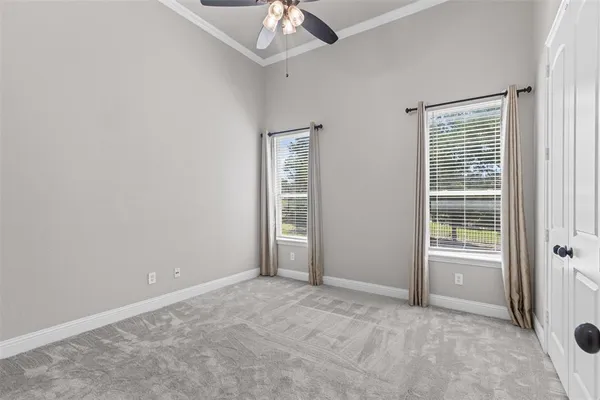 an empty room with chandelier fan