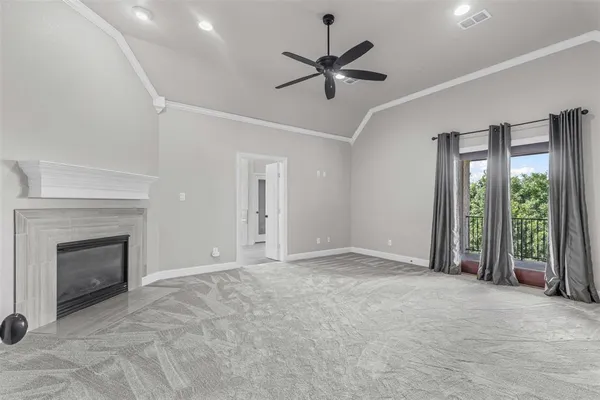 a view of an empty room with a fireplace and a window