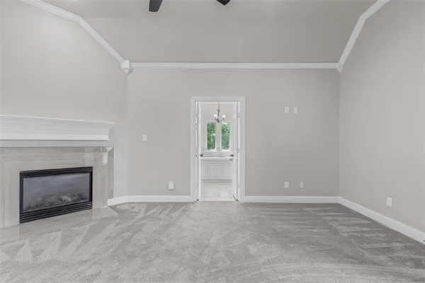 a view of empty room with a fireplace