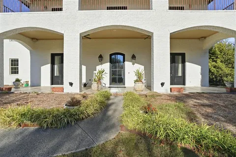 a front view of the house with garden