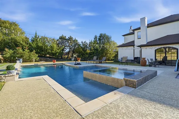 a view of a swimming pool with an outdoor space and seating area