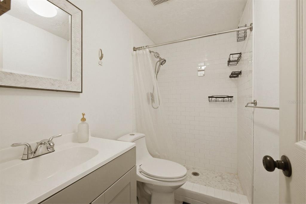 4276 Rudder Way New Port Richey, FL 34652 - Photo 16 of 29 a bathroom with a sink a toilet and shower