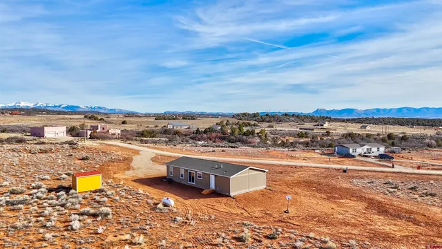 an aerial view of residential house and an outdoor space