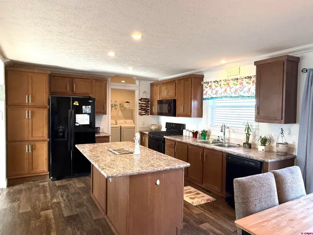 a kitchen with a sink a counter top space and stainless steel appliances