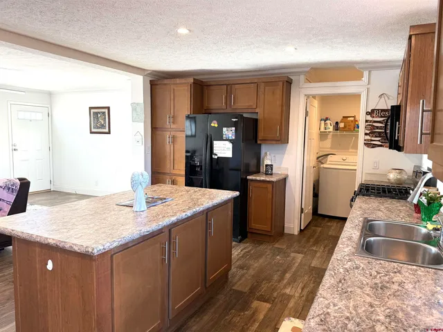 a kitchen with a sink cabinets and refrigerator