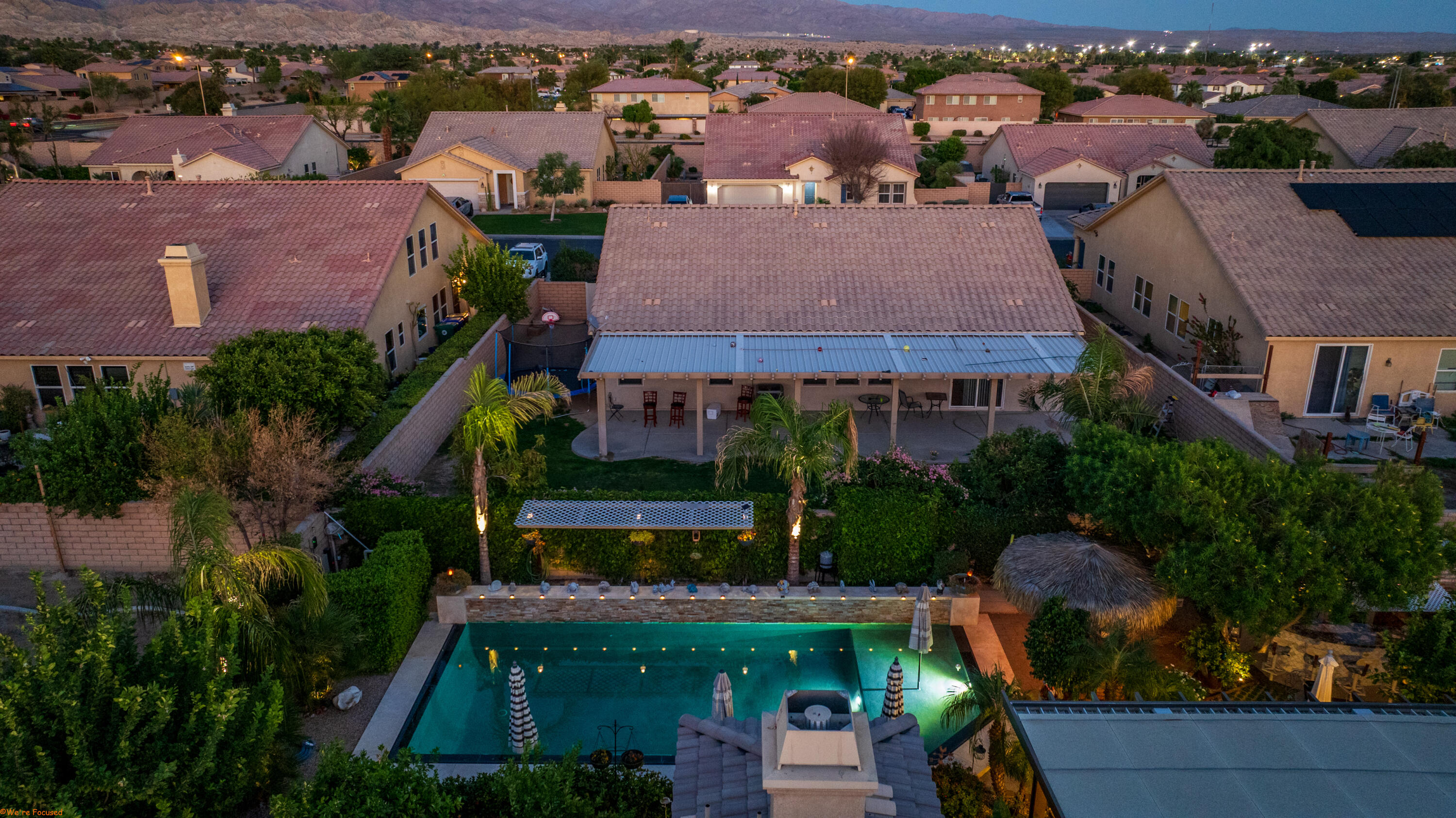 an aerial view of a house with a garden and lake view