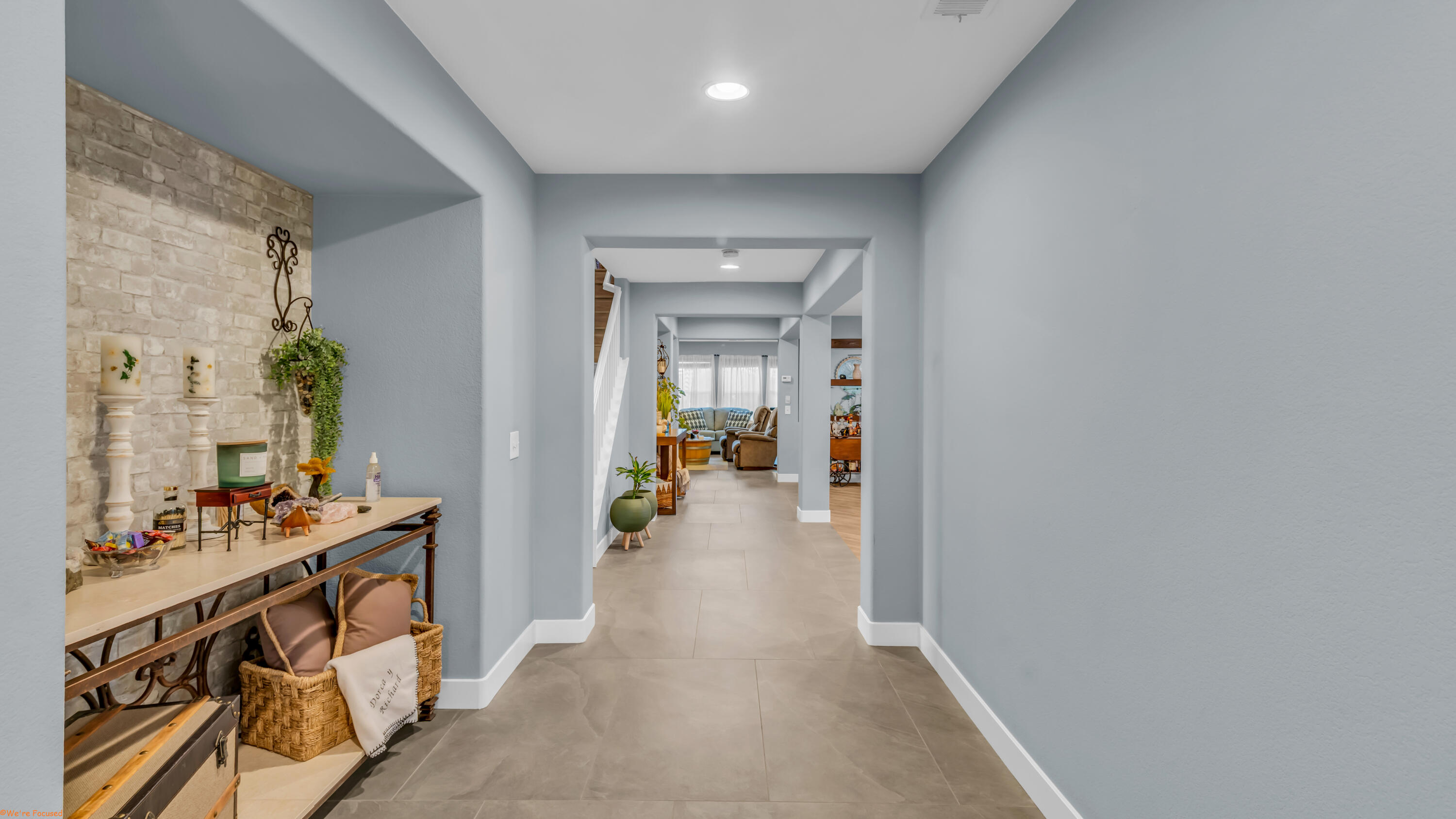 41126 Prospect Court Indio, CA 92203 - Photo 12 of 69 a view of a hallway to a livingroom with wooden floor and furniture