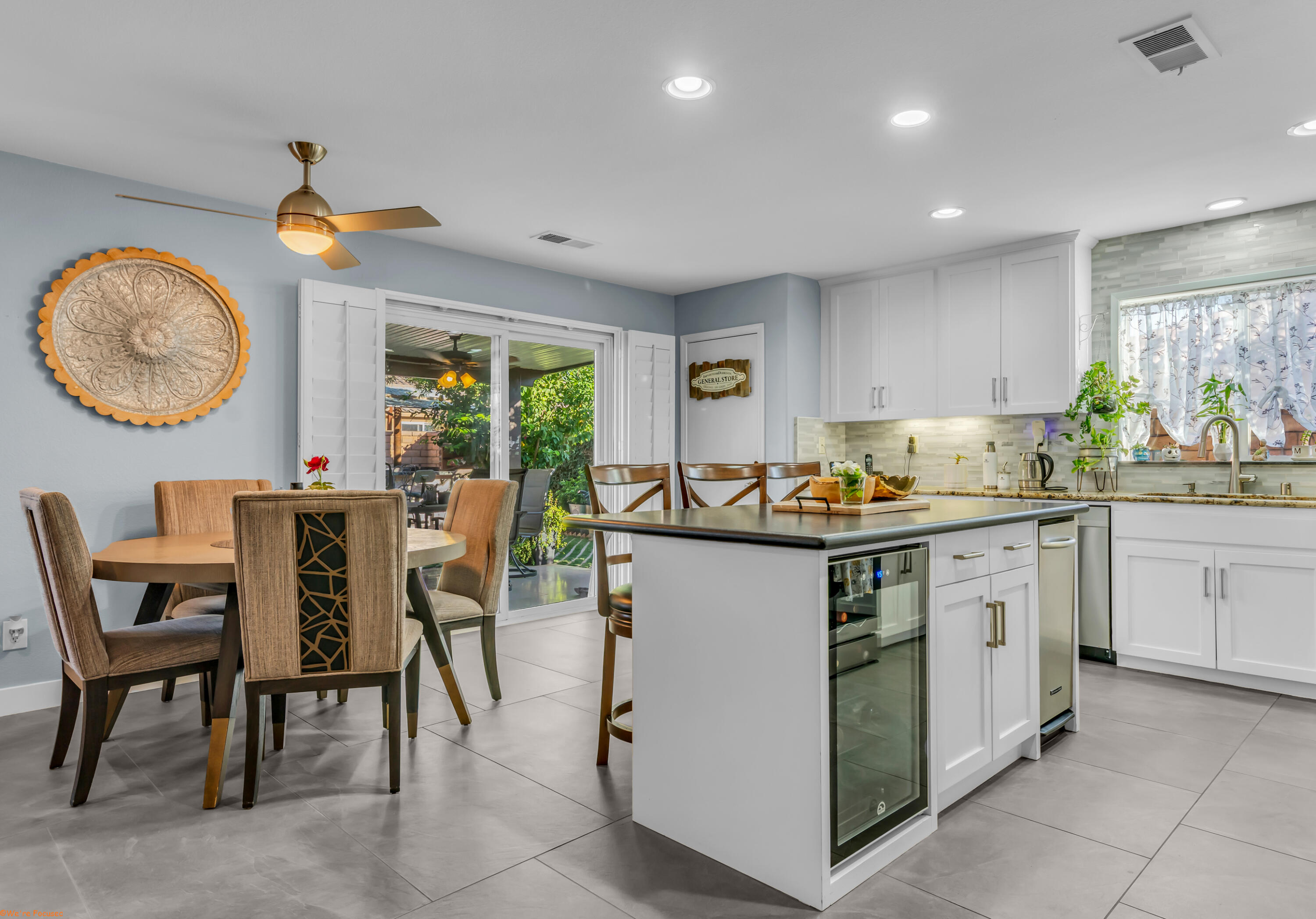 41126 Prospect Court Indio, CA 92203 - Photo 18 of 69 a kitchen that has a lot of cabinets in it with a dining table and chairs