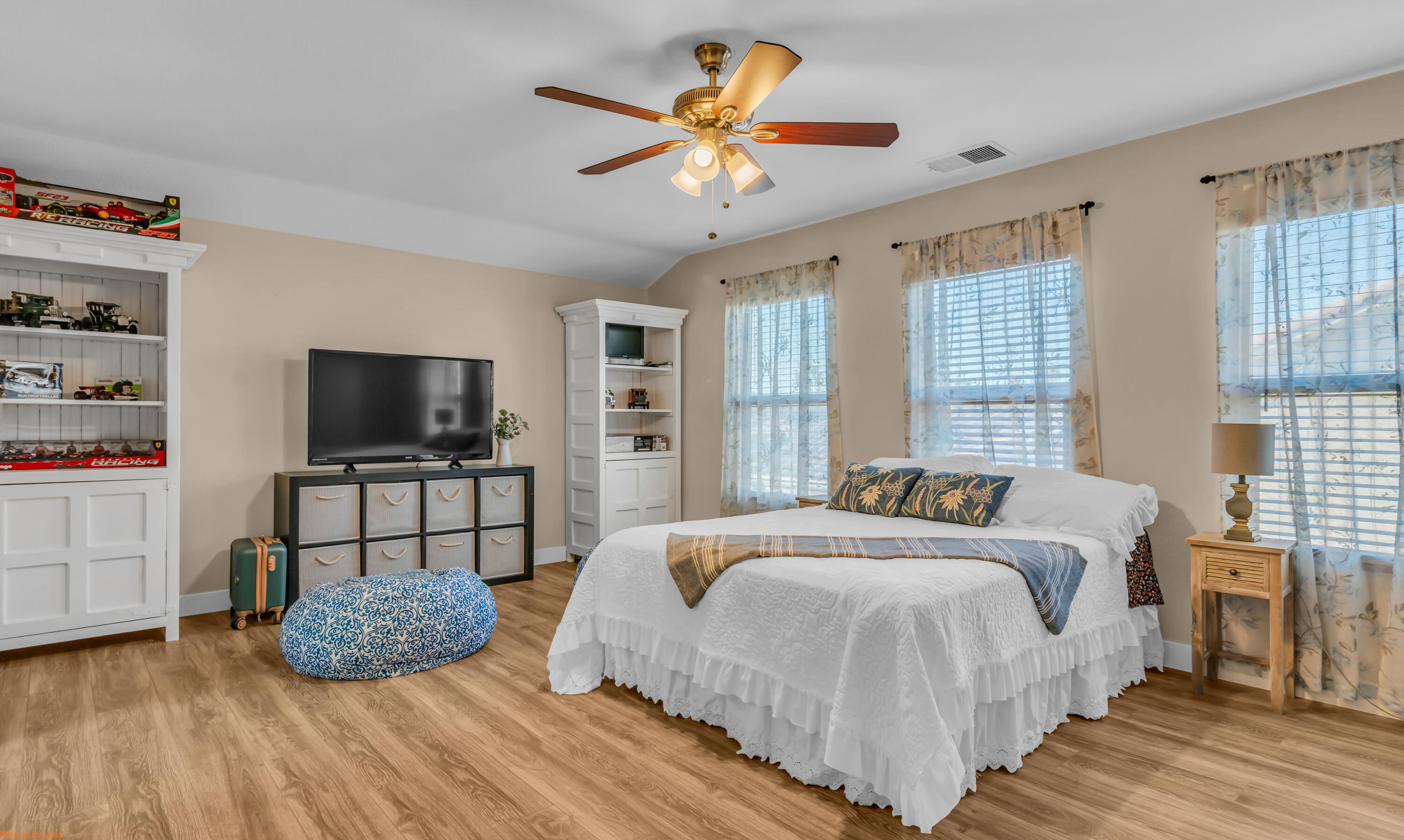 41126 Prospect Court Indio, CA 92203 - Photo 47 of 69 a bedroom with a bed a flat screen tv and a chandelier