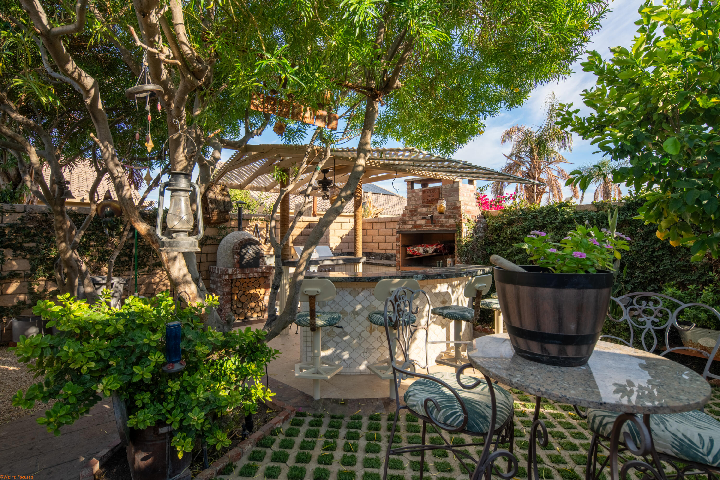 41126 Prospect Court Indio, CA 92203 - Photo 62 of 69 a view of a patio with table and chairs potted plants and large tree