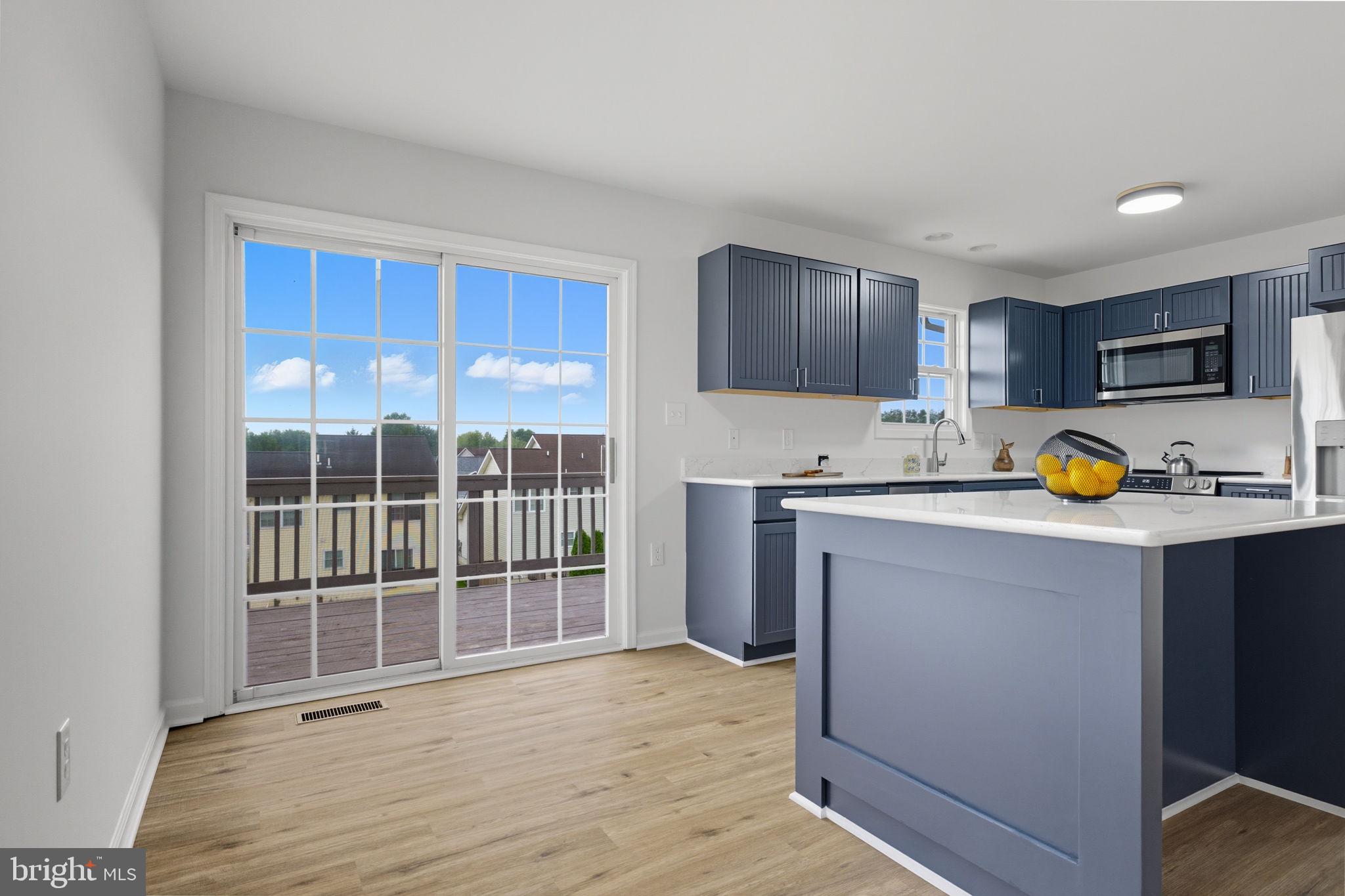55 Fuzzy Tail Drive Ranson, WV 25438 - Photo 11 of 61 a view of kitchen with wooden floor and windows