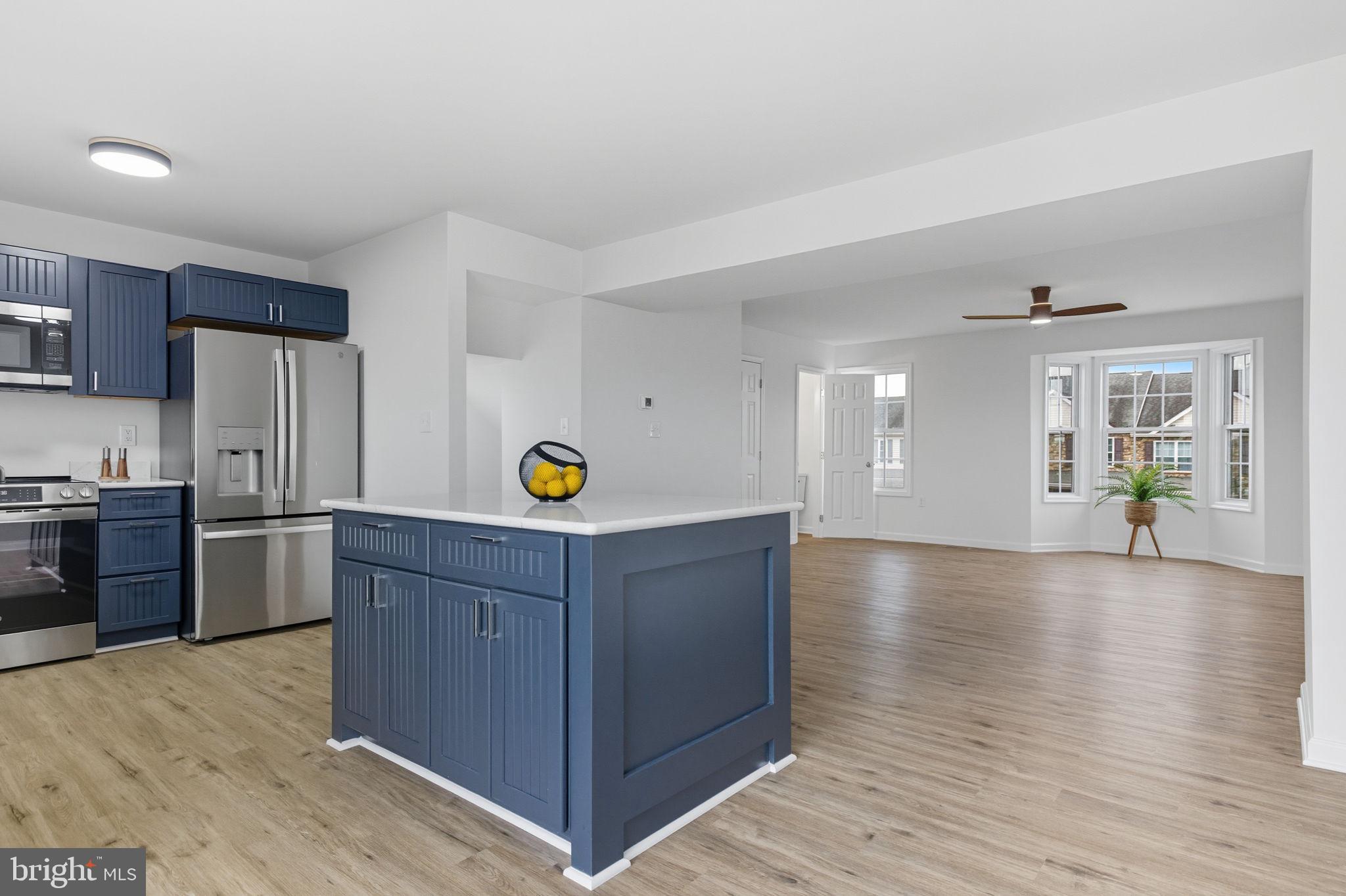 55 Fuzzy Tail Drive Ranson, WV 25438 - Photo 14 of 61 a kitchen with a wooden floor and cabinets