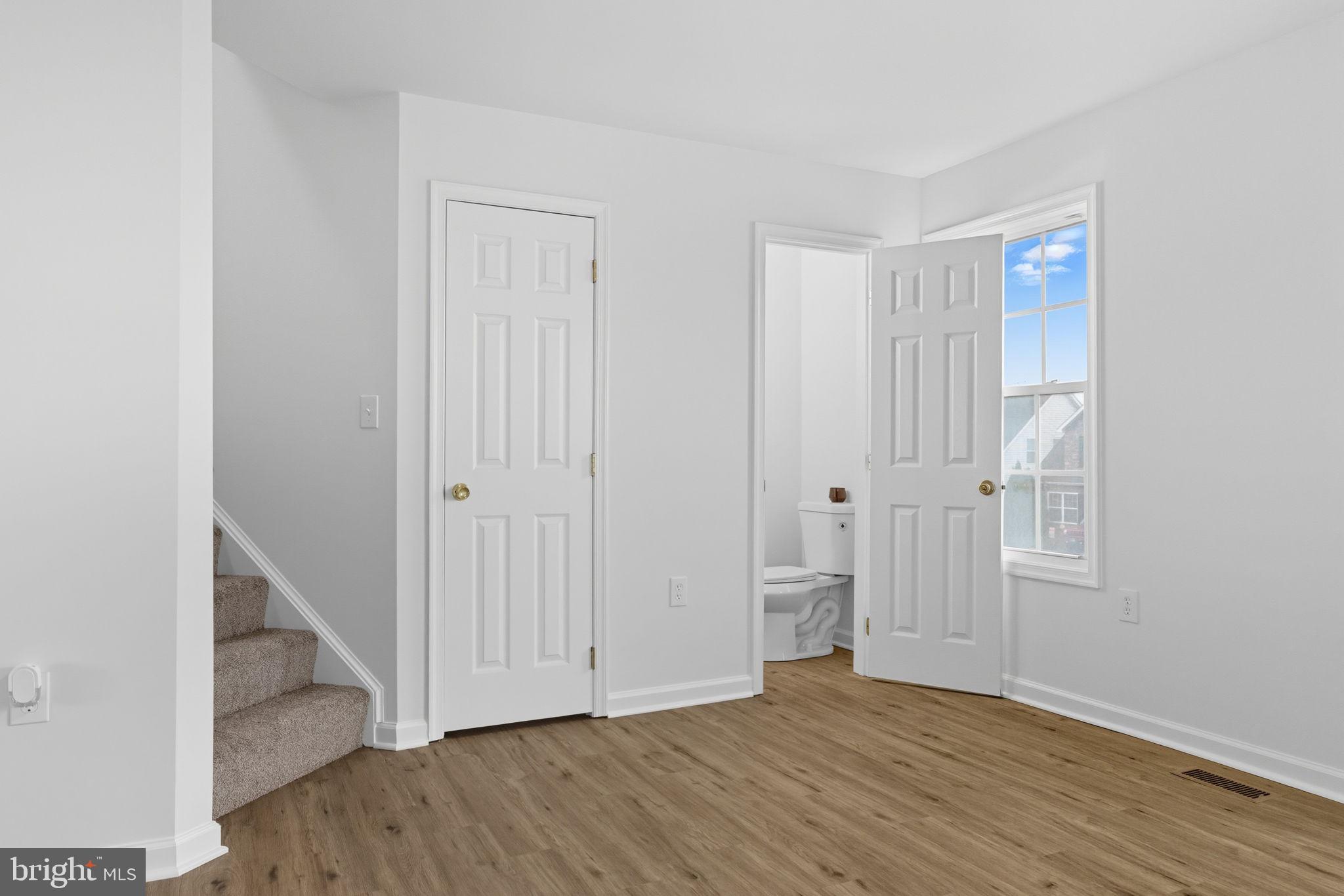 55 Fuzzy Tail Drive Ranson, WV 25438 - Photo 18 of 61 an empty room with wooden floor and entryway