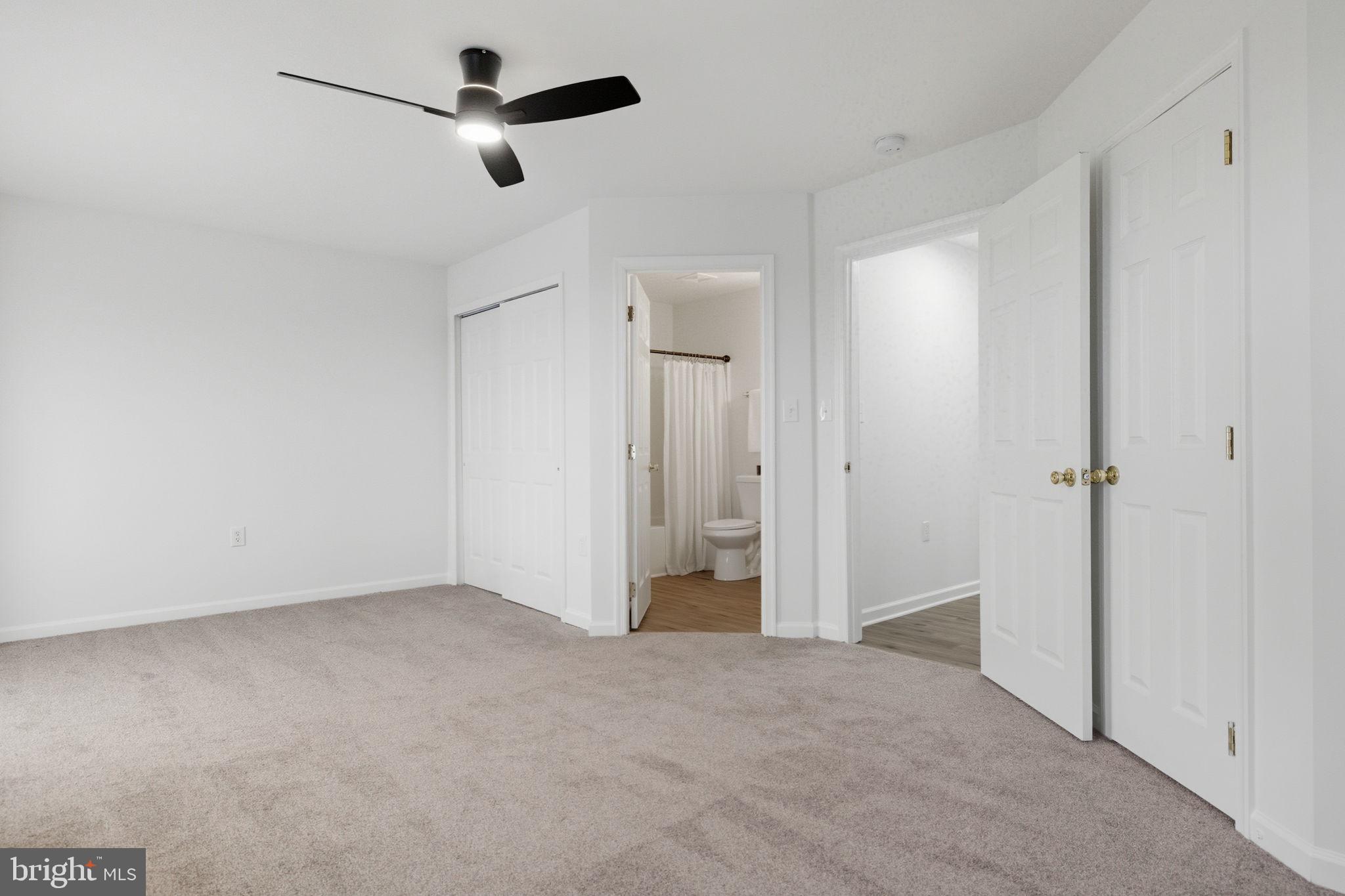 55 Fuzzy Tail Drive Ranson, WV 25438 - Photo 30 of 61 an empty room with closet and a chandelier fan