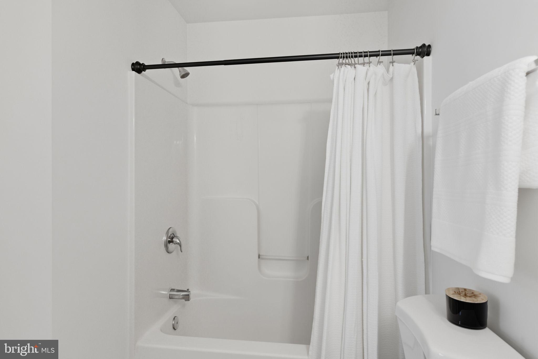 55 Fuzzy Tail Drive Ranson, WV 25438 - Photo 33 of 61 a bathroom with a shower and a tub