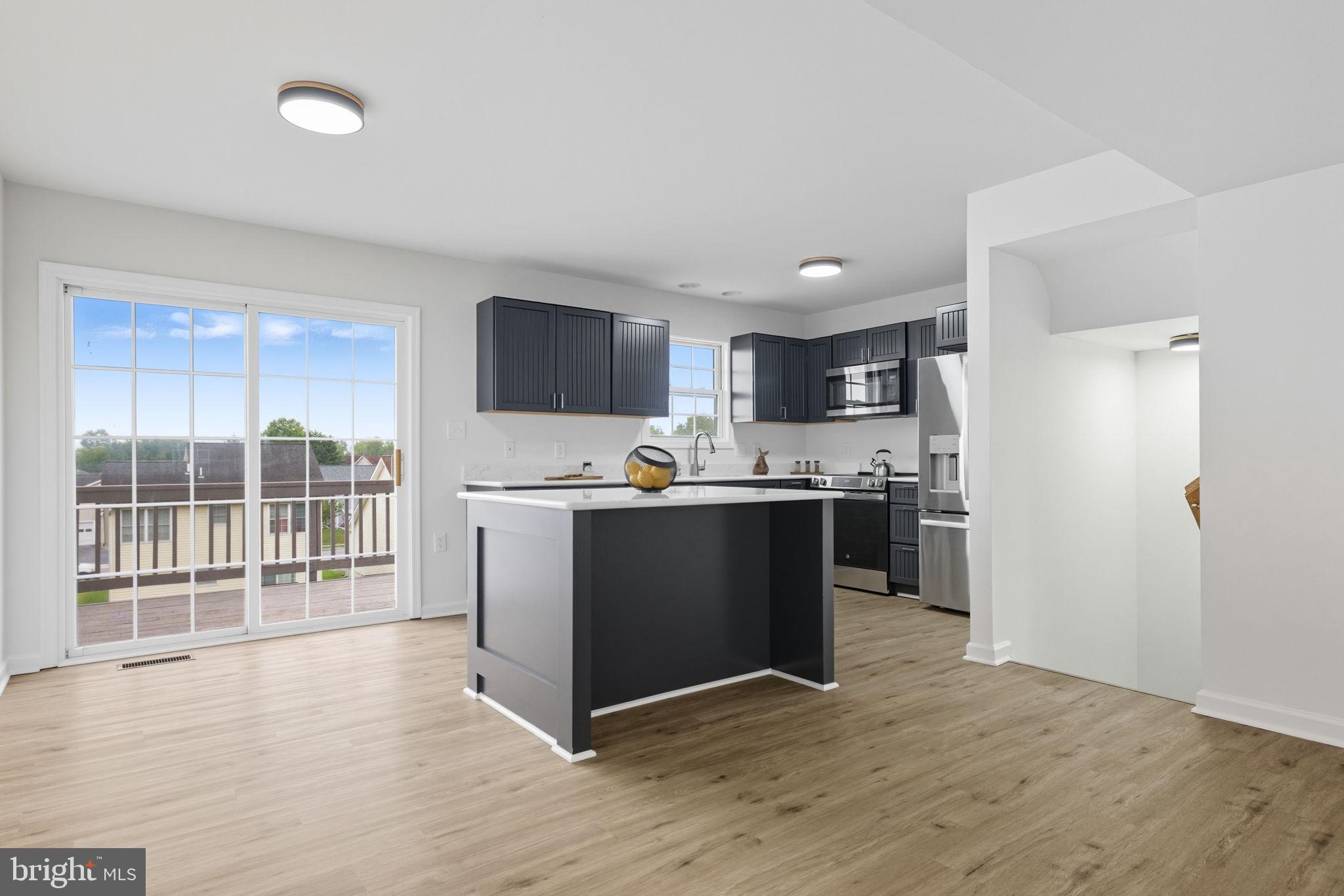 55 Fuzzy Tail Drive Ranson, WV 25438 - Photo 5 of 61 a kitchen with stainless steel appliances granite countertop a refrigerator stove top oven and sink
