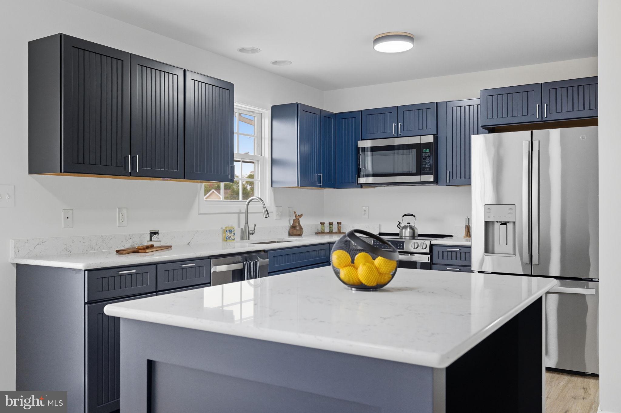 55 Fuzzy Tail Drive Ranson, WV 25438 - Photo 6 of 61 a kitchen with a sink a stove and refrigerator