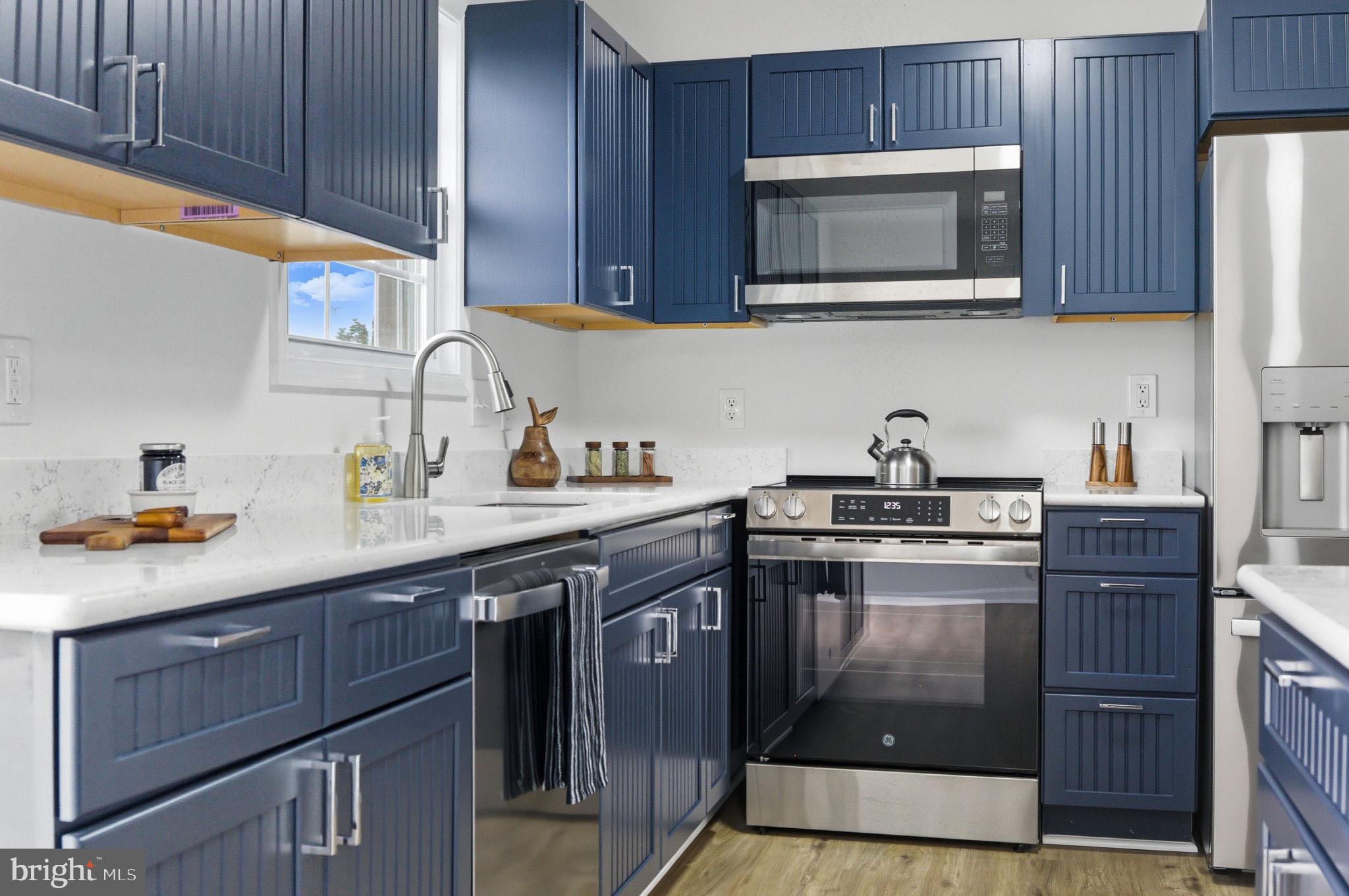 55 Fuzzy Tail Drive Ranson, WV 25438 - Photo 8 of 61 a kitchen with stainless steel appliances granite countertop wooden cabinets a stove top oven a sink and dishwasher