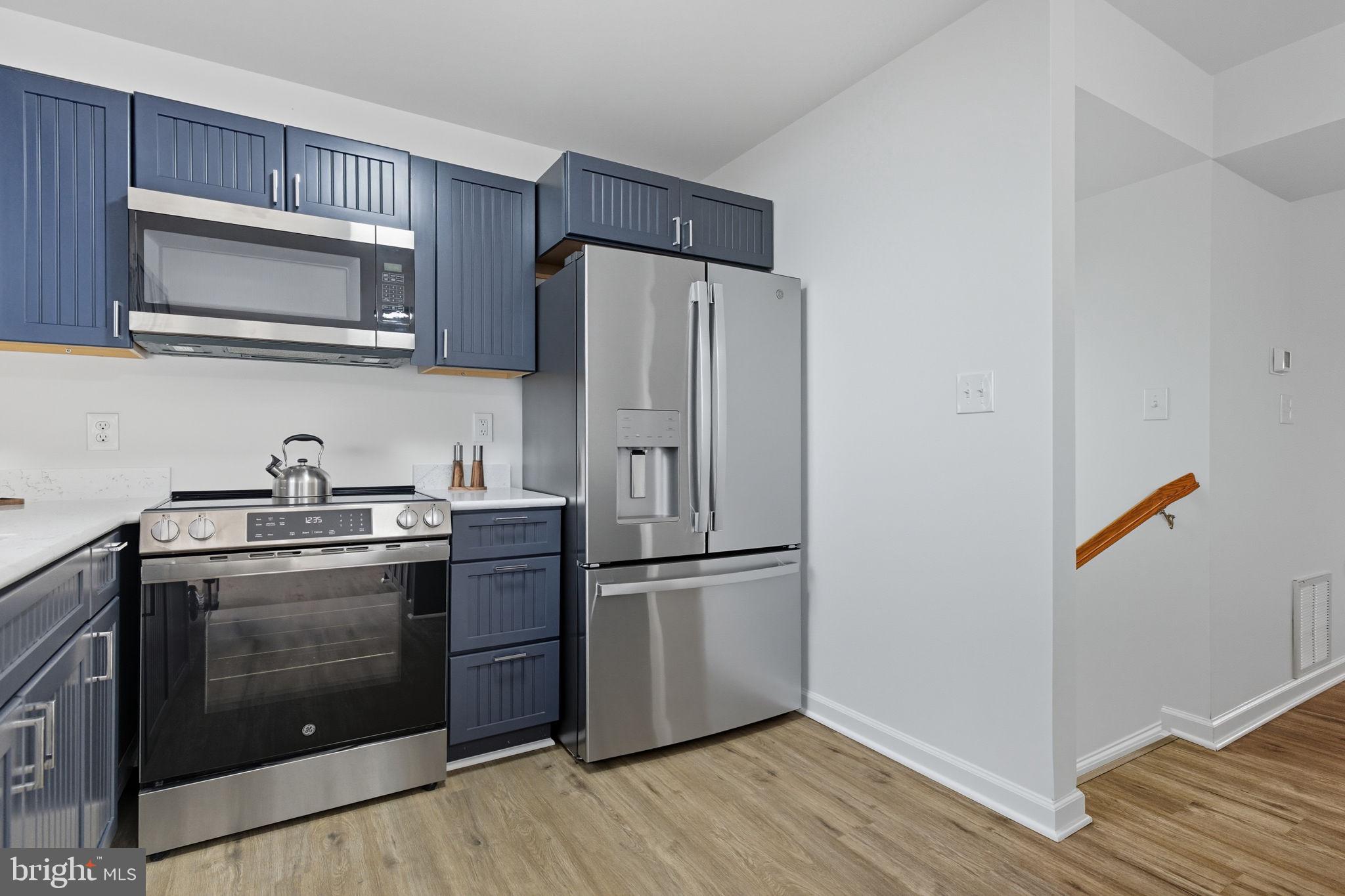 55 Fuzzy Tail Drive Ranson, WV 25438 - Photo 10 of 61 a kitchen with stainless steel appliances granite countertop a refrigerator stove and microwave