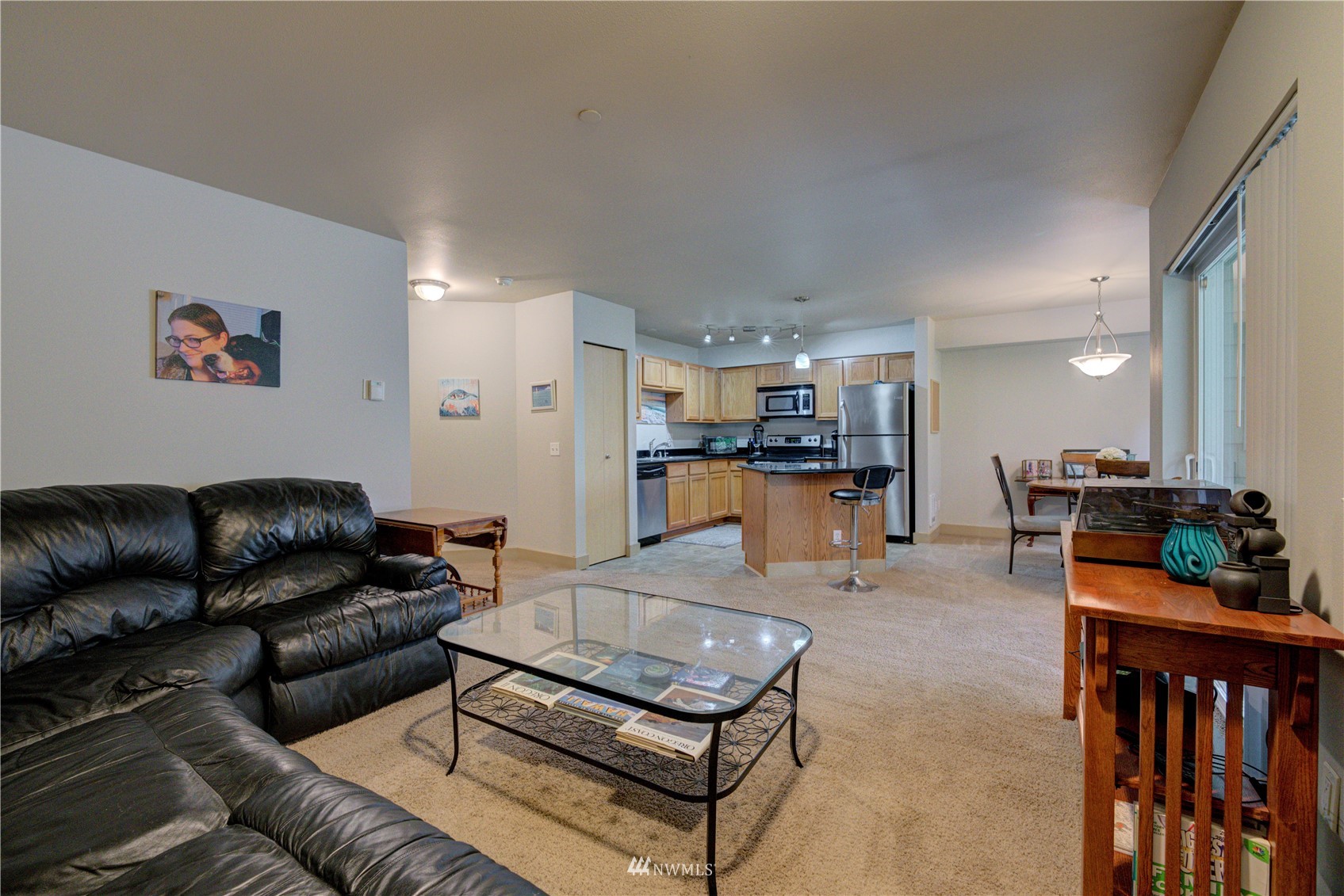 5809 Hwy Place, Unit B103 Everett, WA 98203 - Photo 11 of 30 a living room with furniture and kitchen view