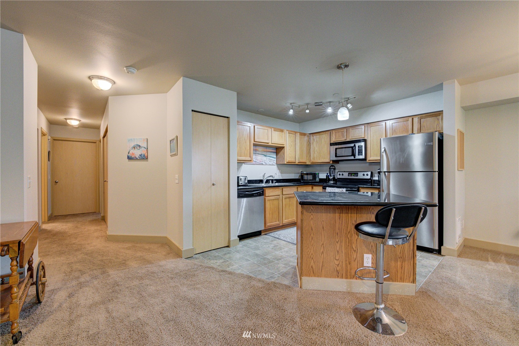 5809 Hwy Place, Unit B103 Everett, WA 98203 - Photo 12 of 30 a kitchen with stainless steel appliances granite countertop a refrigerator and a stove top oven