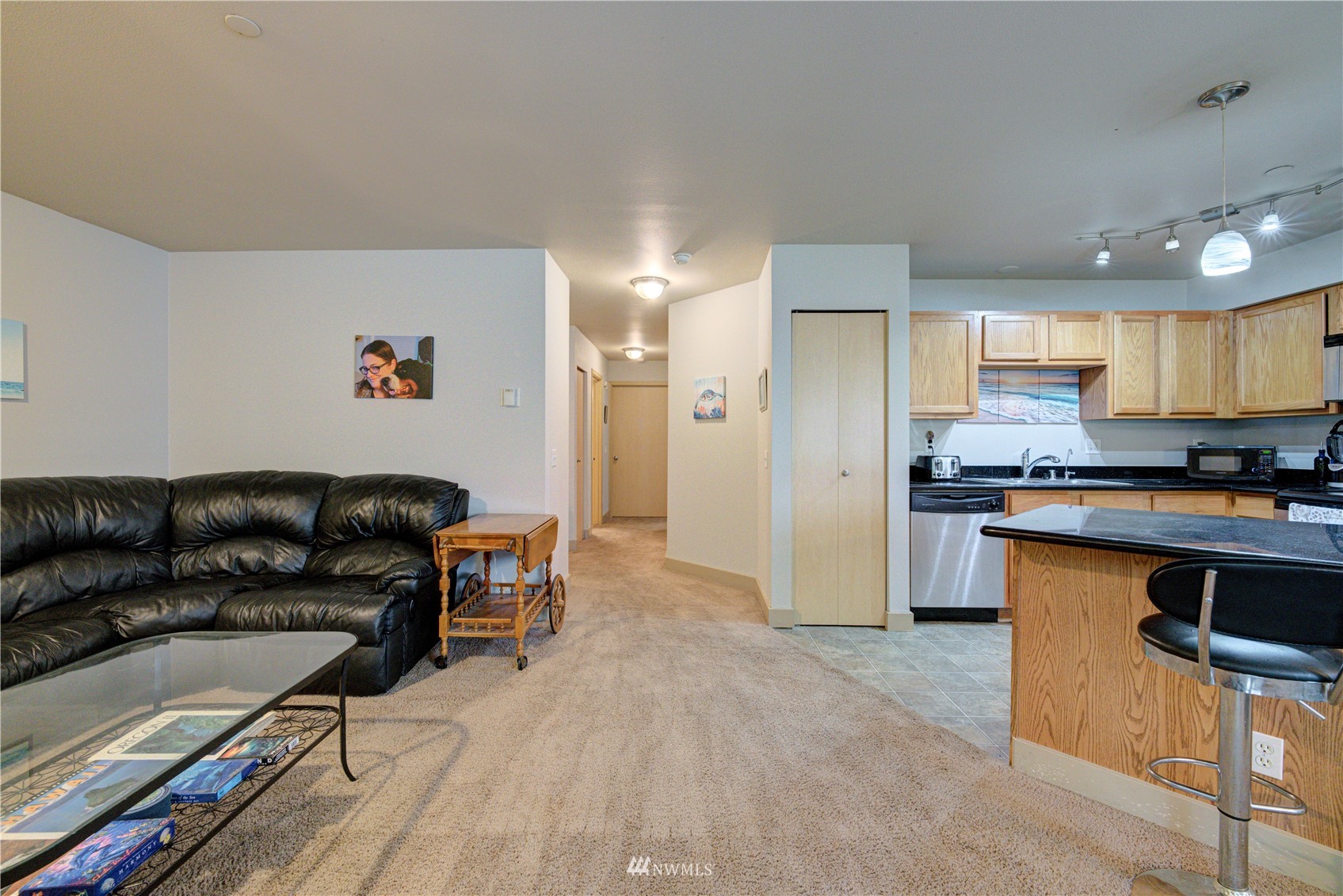 5809 Hwy Place, Unit B103 Everett, WA 98203 - Photo 9 of 30 a living room with stainless steel appliances kitchen island granite countertop furniture and a refrigerator