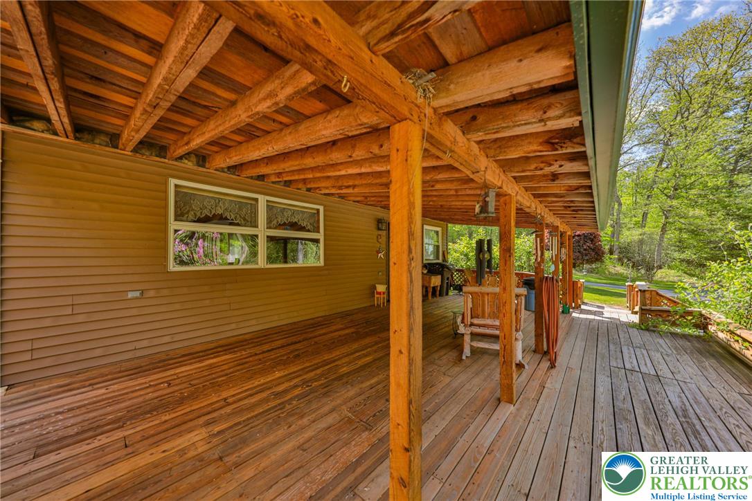 331 Cranberry Creek Road Cresco, PA 18326 - Photo 92 of 95 A spacious wooden deck provides an inviting outdoor living area, perfect for enjoying nature.