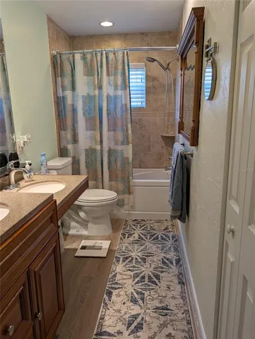 a kitchen with stainless steel appliances granite countertop a kitchen island a stove and a sink