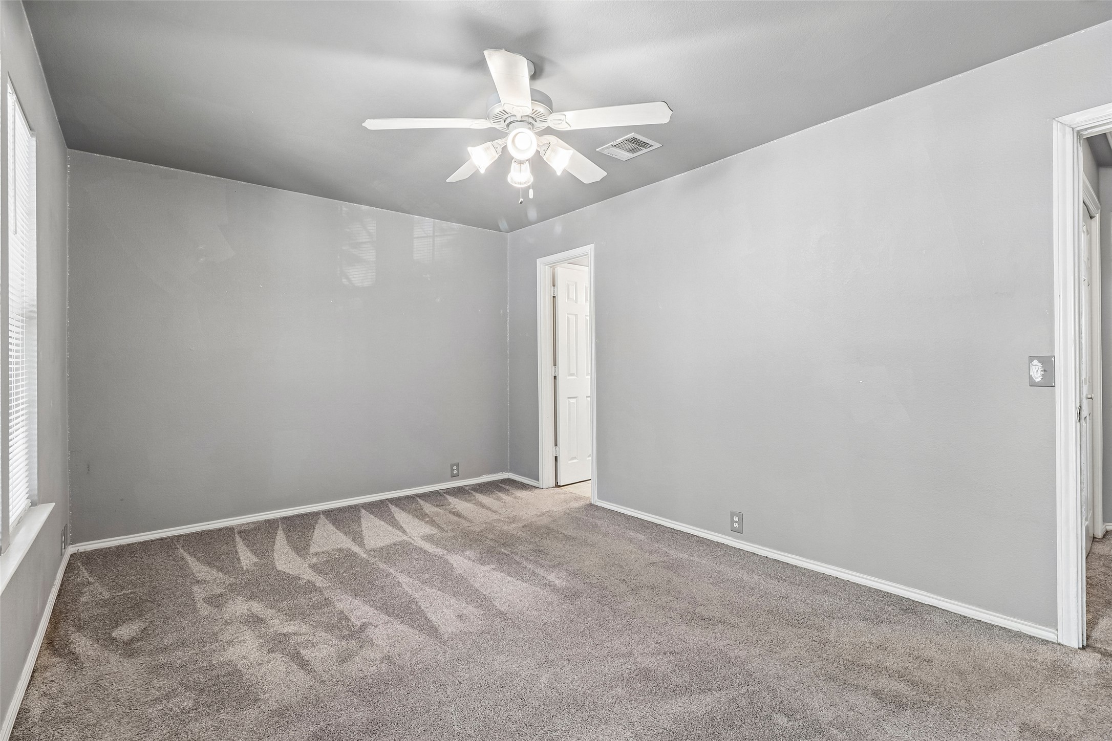 311 A Utterback Kyle, TX 78640 - Photo 23 of 40 an empty room with a chandelier fan and windows