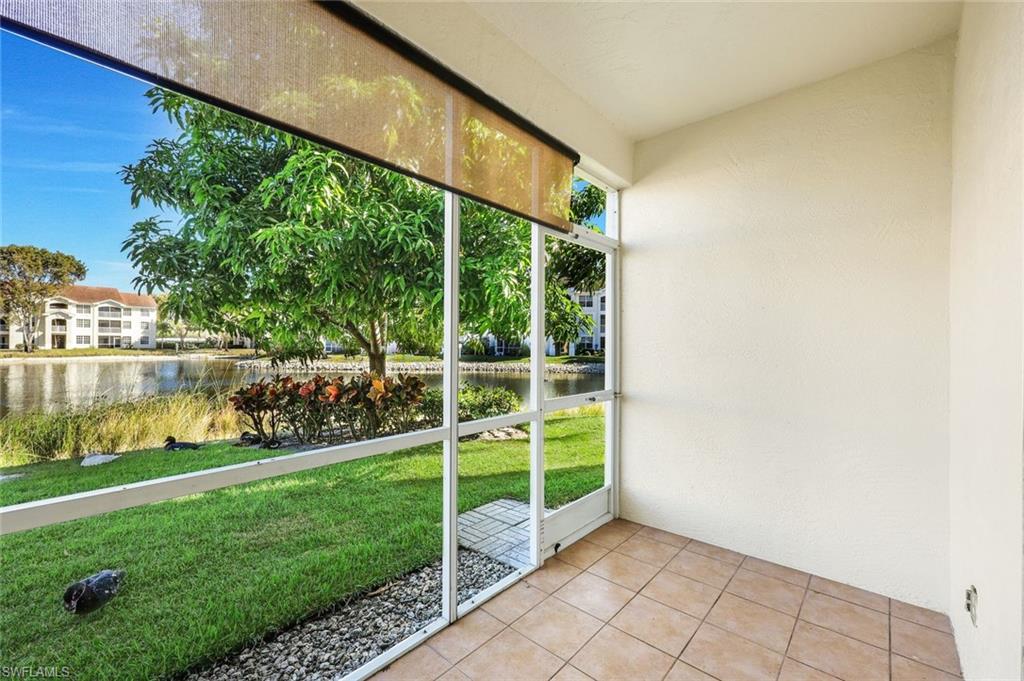 4620 St Croix Lane, Unit 911 Naples, FL 34109 - Photo 15 of 26 Screened-in sunroom with a view of the lake