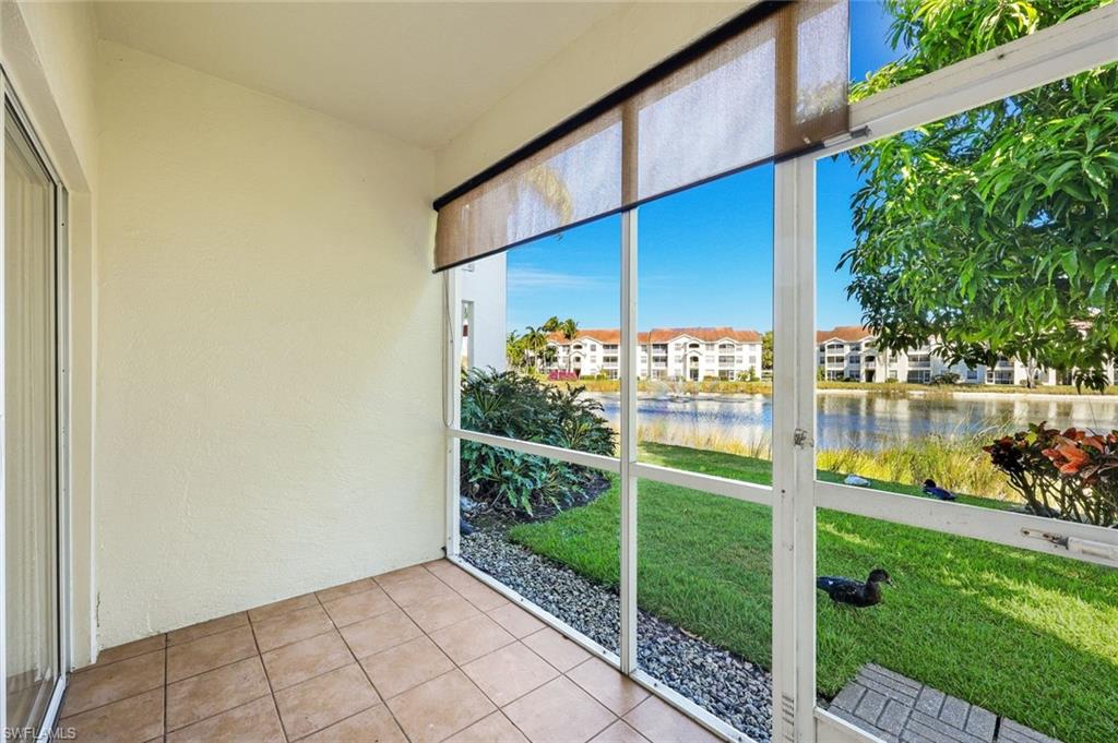 4620 St Croix Lane, Unit 911 Naples, FL 34109 - Photo 16 of 26 Screened-in sunroom with a view of the lake