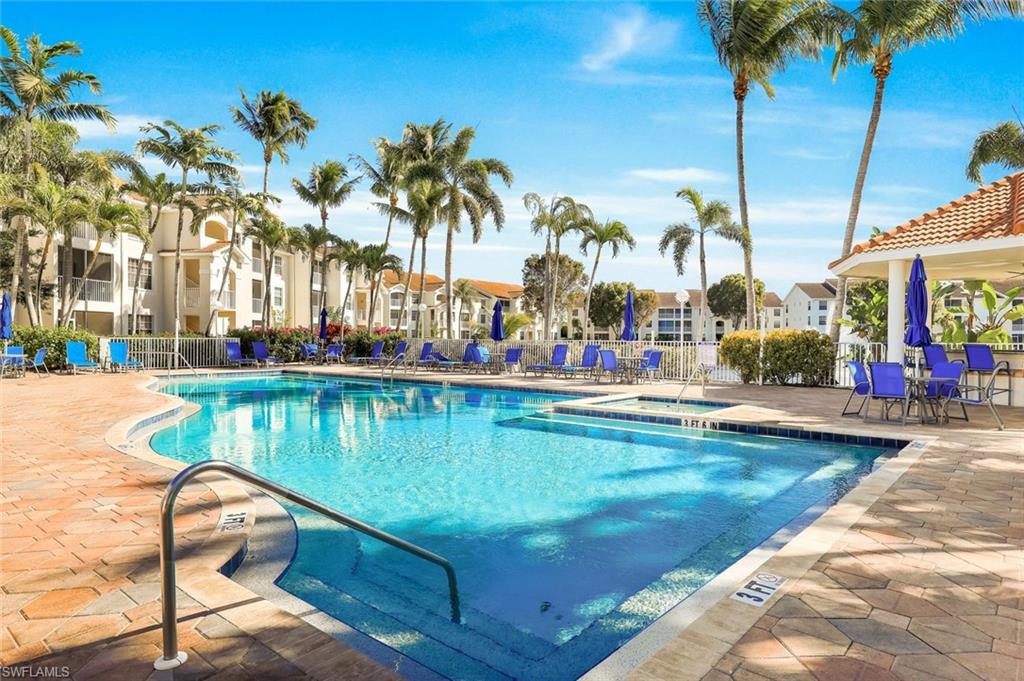 4620 St Croix Lane, Unit 911 Naples, FL 34109 - Photo 17 of 26 Community pool with a hot tub and pool bar for entertaining