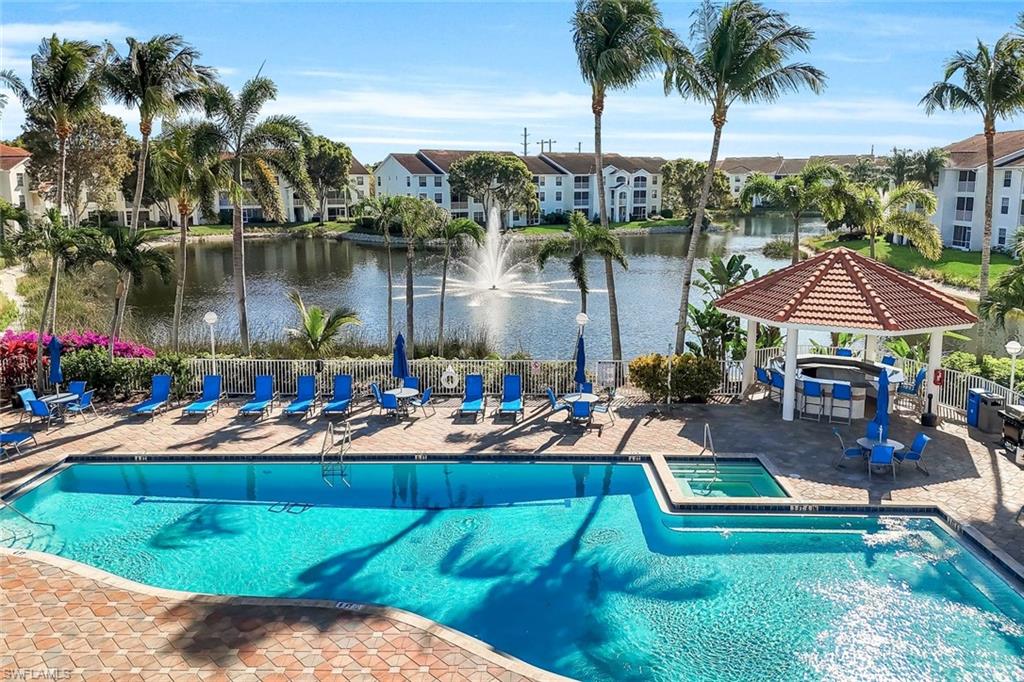 4620 St Croix Lane, Unit 911 Naples, FL 34109 - Photo 18 of 26 Community pool and hot tub with a party gazebo.