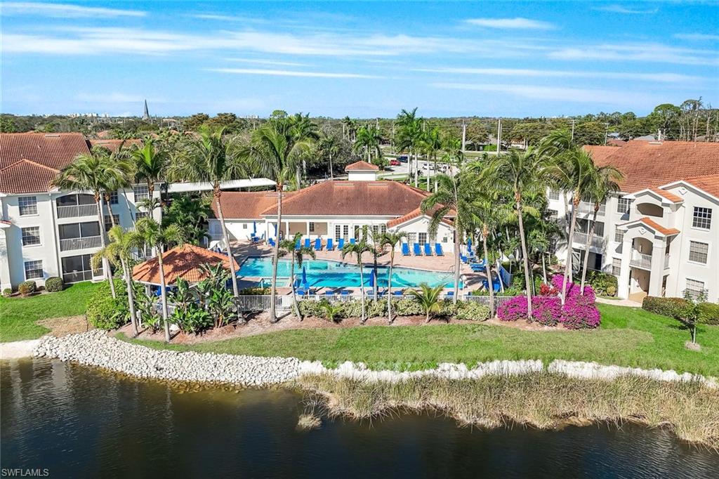 4620 St Croix Lane, Unit 911 Naples, FL 34109 - Photo 19 of 26 Aerial view of the clubhouse, pool, hot tub and party gazebo