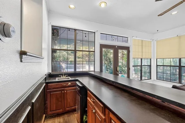 a kitchen with a large window and a sink
