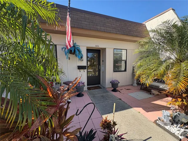 a view of a house with potted plants
