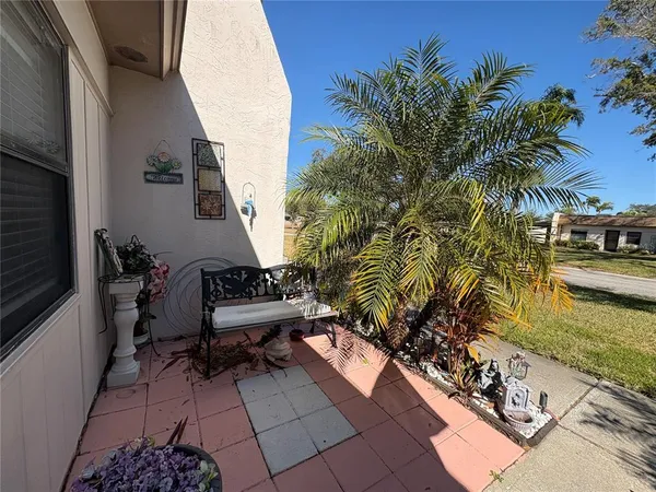 a view of a balcony with chairs and potted plants