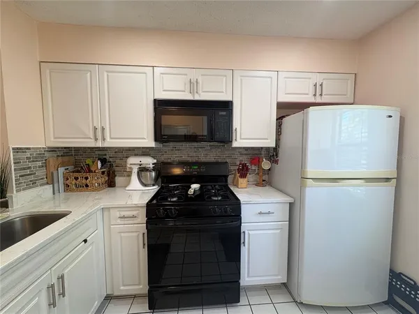 a kitchen with a refrigerator stove and microwave