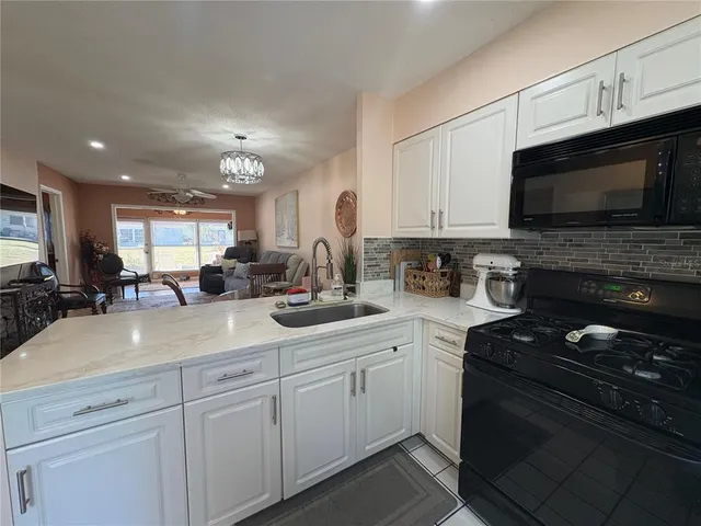 a kitchen with sink stainless steel appliances and cabinets