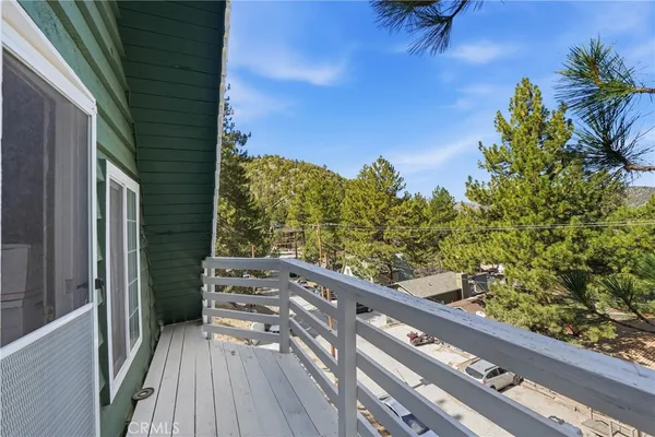 a view of a balcony with wooden floor and outdoor space