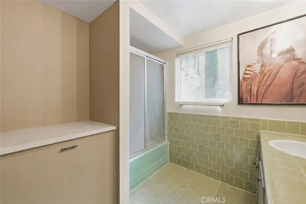 a bathroom with a shower and a sink